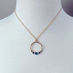 Avon gold tone open circle necklace with blue stones